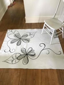 white flower rug with chair