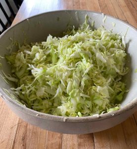 cabbage shredded in a stoneware bowl 