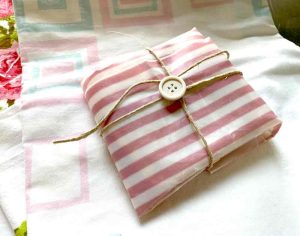 striped beeswax wrap with tie and button