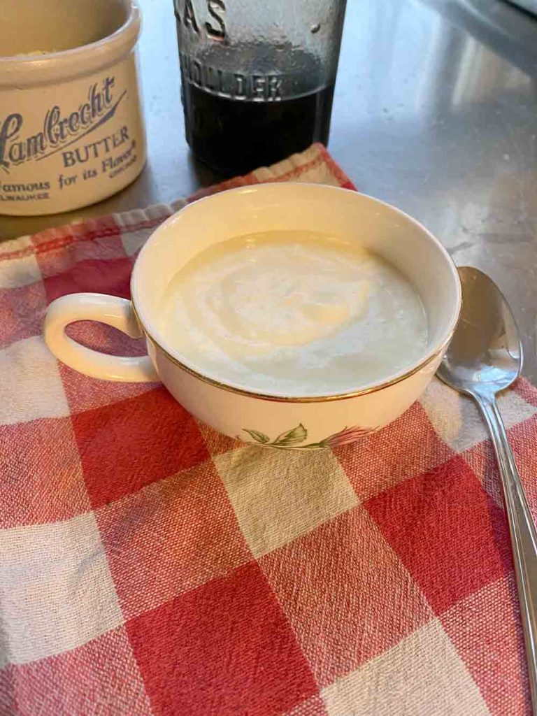 cup of yogurt on checkered tablecloth