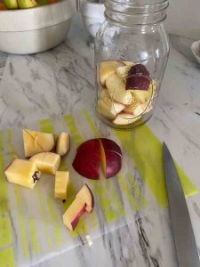 cut apples with knife and jar